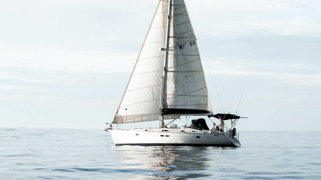 Sailing yacht on glistening calm water