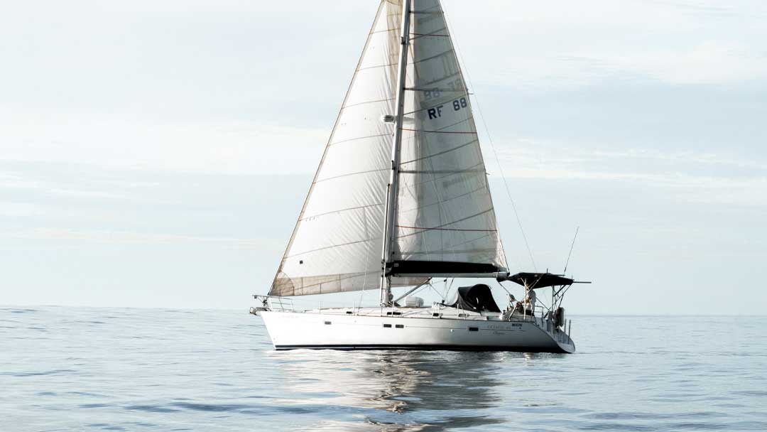 Sailing yacht on glistening calm water