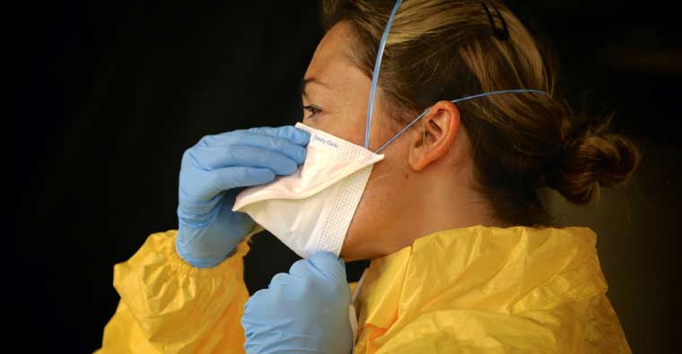 A woman wearing a face mask and blue gloves, keeping her safe from antifouling.