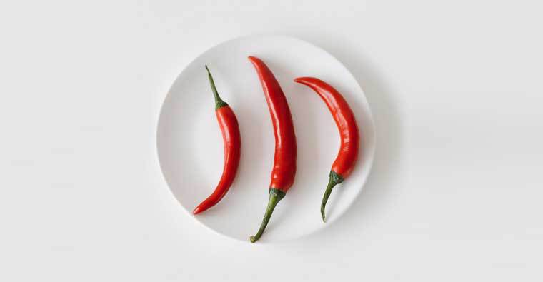 Three Cayenne Peppers on a White Saucer, capsaicin is being used in antifouling coatings.